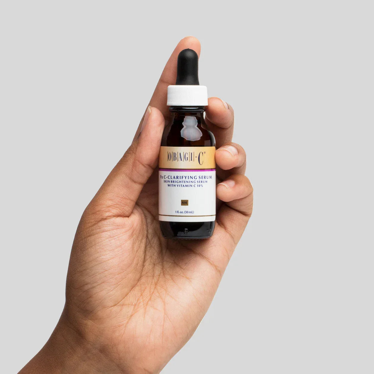 Hand holding a obagi c fx c clarifying serum vitamin c