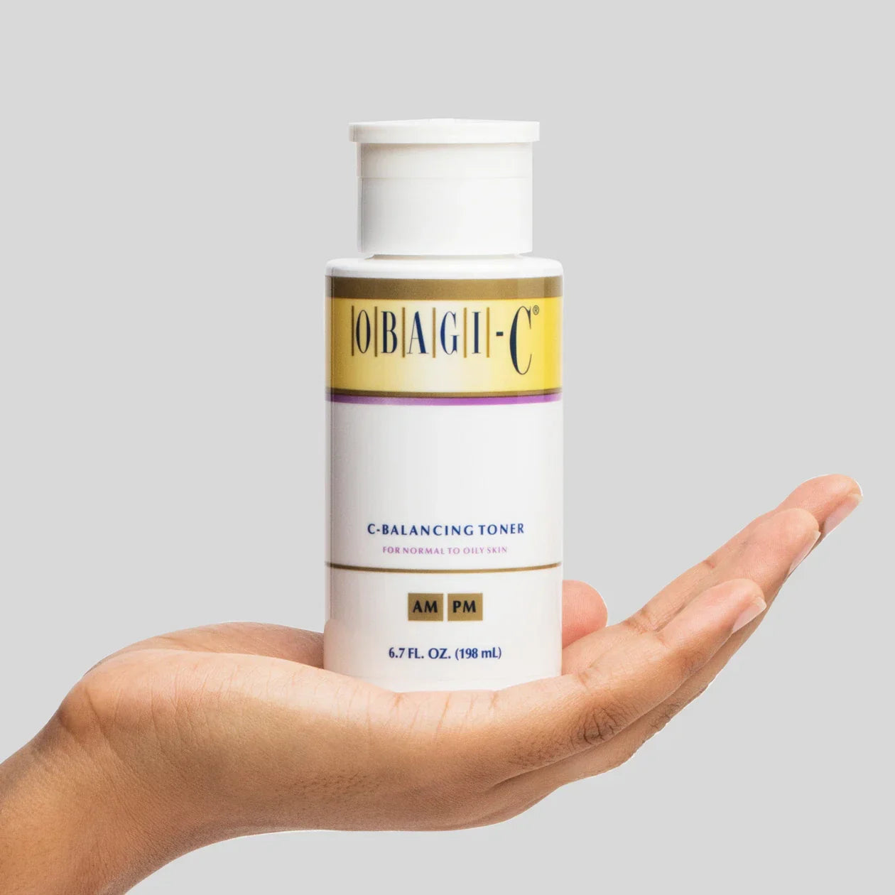 Hand holding a bottle of obagi c fx c balancing toner 