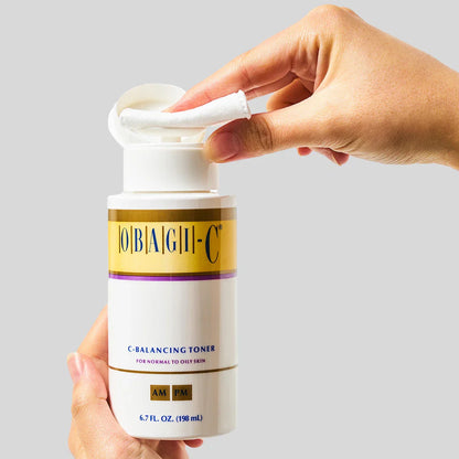 Hand holding a obagi c fx c balancing toner